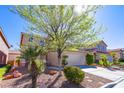 Inviting two-story home with a well-manicured front yard, mature tree, and a convenient two-car garage at 9849 Ridge Hill Ave, Las Vegas, NV 89147