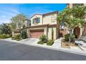 Charming two-story home with a red tile roof, well-maintained landscaping, and an attached two-car garage at 9869 Lime Tree St, Las Vegas, NV 89178