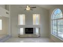 Bright living room with a fireplace, large windows, and sleek marble flooring at 10052 Baystone St, Las Vegas, NV 89141