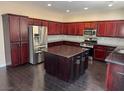 Stylish kitchen with a large island, stainless appliances, and hardwood floors at 10118 Farmington Hall Ct, Las Vegas, NV 89129