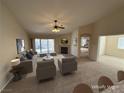 Spacious living area with neutral tones, fireplace, ceiling fan, and sliding door access to the backyard at 10321 Birch Bluff Ln, Las Vegas, NV 89145