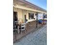 View of covered back patio with seating, potted plants and a pool at 105 Huntly Rd, Las Vegas, NV 89145