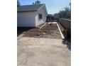 A view of the backyard with decorative rock and concrete pad at 105 Huntly Rd, Las Vegas, NV 89145