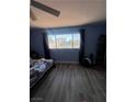 Bedroom featuring a large window with bars, letting in natural light, complemented by neutral walls at 105 Huntly Rd, Las Vegas, NV 89145