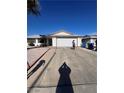 Home exterior with a paved driveway, showcasing the house and surrounding landscape at 105 Huntly Rd, Las Vegas, NV 89145