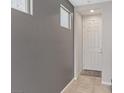 Inviting foyer with neutral walls, tiled flooring, and a white door, creating a bright and clean entrance at 1266 Smokey Valley Ln, Henderson, NV 89002
