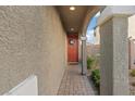 Welcoming front door with a decorative wreath, nestled in a covered entryway with charming architectural details at 1266 Smokey Valley Ln, Henderson, NV 89002