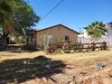 Quaint single-story home with rustic wagon wheel accents and mature trees at 165 W Alma Ave, Overton, NV 89040
