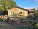 Cozy home featuring rustic wagon wheel fence, a small yard, and quaint architecture at 165 W Alma Ave, Overton, NV 89040