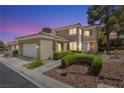 Inviting home exterior showcasing a 2-car garage and manicured landscaping at 2033 Summer Spruce Pl # 102, Las Vegas, NV 89134