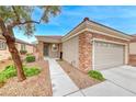 Lovely single-story home showcasing stone accents, a two-car garage, and a neatly landscaped yard at 2522 Darda St, Henderson, NV 89044