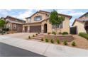Charming two-story stucco home features a three-car garage and well-manicured landscaping at 2575 Hazelburn Ave, Henderson, NV 89044