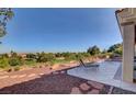 Private outdoor patio with lounge chairs overlooking a golf course and lush landscape at 3032 Highland Falls Dr, Las Vegas, NV 89134