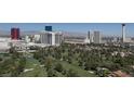 Expansive aerial view of the golf course community near a city skyline with mountains in the distance at 3111 Bel Air Dr # 28A, Las Vegas, NV 89109