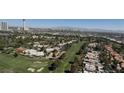 Picturesque aerial view of a golf course community with tree-lined streets, situated near the city at 3111 Bel Air Dr # 28A, Las Vegas, NV 89109