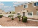 Inviting home exterior with a well-maintained lawn, manicured bushes, and a cozy entryway at 3312 Speckle Summer Pl # 3, North Las Vegas, NV 89084