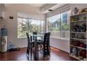 Dining room with hardwood floors, a modern light fixture, and large windows with neighborhood views at 35 E Agate Ave # 208, Las Vegas, NV 89123