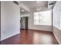 Bright dining area featuring hardwood floors, modern light fixture, and large windows at 35 E Agate Ave # 208, Las Vegas, NV 89123