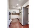 Kitchen with white cabinets, granite counters, stainless appliances and hardwood flooring at 35 E Agate Ave # 208, Las Vegas, NV 89123