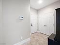 Clean entryway featuring tile flooring, closet, security system, and neutral tones, perfect for any decor at 4563 Townwall St, Las Vegas, NV 89115