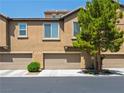Townhouse exterior with attached garages, offering convenient parking and a well-maintained appearance at 4563 Townwall St, Las Vegas, NV 89115