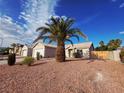 Inviting single-story home with desert landscaping and a mature palm tree at 4704 Wild Oak Way, North Las Vegas, NV 89031