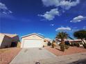 Well-maintained single-Gathering home featuring a two-car garage and manicured front yard at 4704 Wild Oak Way, North Las Vegas, NV 89031