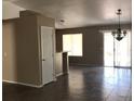 Open-concept living room with tile floors, natural light, and sliding glass door to the yard at 4704 Wild Oak Way, North Las Vegas, NV 89031