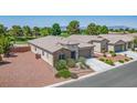 This single-story home boasts desert landscaping, a stone facade, and an attached two-car garage at 5235 E La Campana Dr, Pahrump, NV 89061