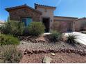 Inviting home with well-maintained desert landscaping, stone accents, and a neutral color palette at 5235 E La Campana Dr, Pahrump, NV 89061