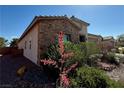 Side view of a charming home featuring stone accents and well-maintained desert landscaping at 5235 E La Campana Dr, Pahrump, NV 89061