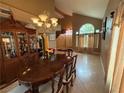 Open concept view of the dining and entry way featuring a chandelier and large china cabinet at 5517 Rock Creek Ln, Las Vegas, NV 89130