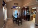 Charming dining room featuring an elegant chandelier, ornate china cabinet, and comfortable seating for six at 5517 Rock Creek Ln, Las Vegas, NV 89130