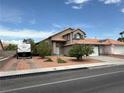 Inviting two-story home boasts a well-kept yard, dual driveways, and a classic Southwest design at 5517 Rock Creek Ln, Las Vegas, NV 89130