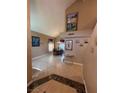 Inviting foyer with tile flooring, high ceilings, and decorative wall art in a well-lit home at 5517 Rock Creek Ln, Las Vegas, NV 89130