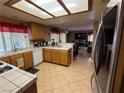 Functional kitchen with oak cabinets, bright lighting, and an efficient layout open to the living room at 5517 Rock Creek Ln, Las Vegas, NV 89130