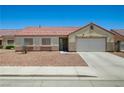 Charming single-story home with a well-manicured rock front yard, and a two car garage at 5730 Coleman St, North Las Vegas, NV 89031