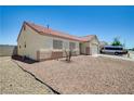 View of the neutral colored single-story home showing the rock yard and long driveway at 5730 Coleman St, North Las Vegas, NV 89031