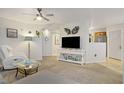 Bright living room with neutral carpet, ceiling fan and a view into the kitchen at 698 S Racetrack Rd # 1714, Henderson, NV 89015