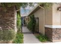Inviting courtyard gate with decorative floral wreath and detailed stone accents at 7126 Mirkwood Ave, Las Vegas, NV 89178