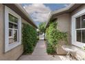 Charming courtyard entrance with lush greenery, decorative accents, and inviting walkway at 7126 Mirkwood Ave, Las Vegas, NV 89178