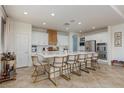 Bright kitchen with large island, marble countertops, stainless steel appliances and stylish seating at 7126 Mirkwood Ave, Las Vegas, NV 89178