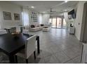 Open-concept living area with tile flooring, a dining table, and a comfortable seating area at 782 Omaggio Pl, Henderson, NV 89011