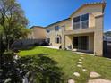 Well manicured backyard with green grass, a small balcony, and a basketball hoop at 7821 Red Leaf Dr, Las Vegas, NV 89131