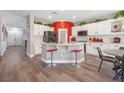Spacious kitchen featuring white cabinets, a center island with seating, and modern appliances at 7821 Red Leaf Dr, Las Vegas, NV 89131