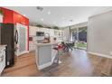 Bright kitchen with white cabinets, a center island, and adjacent dining area with access to the backyard at 7821 Red Leaf Dr, Las Vegas, NV 89131