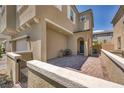 View of the home's covered porch with outdoor seating and a wrought iron fence at 8055 Tank Loop St, Las Vegas, NV 89166
