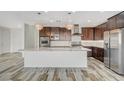 Spacious kitchen featuring a large island, stainless steel appliances, and modern light fixtures at 8754 Moon Crater Ave, Las Vegas, NV 89178