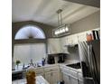 Well-lit kitchen with white cabinets, modern appliances, and ample counter space at 9036 Cotton Rose Way, Las Vegas, NV 89134