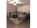 Spacious living room featuring a plush sectional sofa, stylish rug, and modern decor at 9036 Cotton Rose Way, Las Vegas, NV 89134